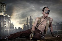 a man in a steampunk outfit laying on the ground